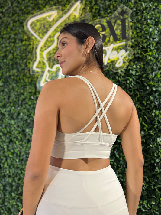 Top deportivo beige de tirantes cruzados en la espalda